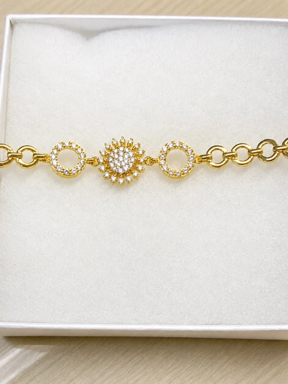 Gold open circle bracelet with CZ flower and circle pave accents